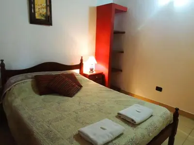 a bedroom with a bed with two towels on it at Alma Mora in Merlo