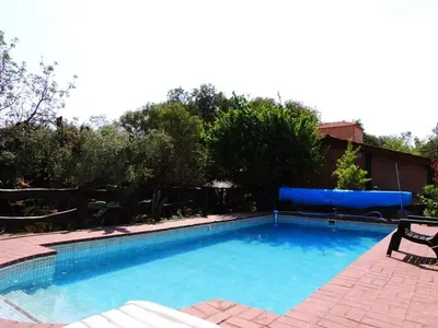 a large swimming pool in a yard with a bench at Alma Mora in Merlo