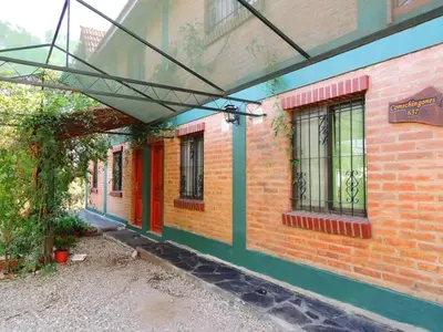 an outside view of a brick building with an overhang at Alma Mora in Merlo