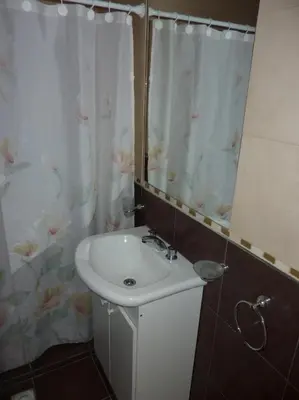 a bathroom with a sink and a shower curtain at Dúplex El Ceibo in Villa Carlos Paz