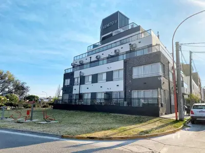 a building with a sign on the top of it at Veneto II in Villa Carlos Paz