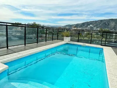a swimming pool on the roof of a building at Veneto II in Villa Carlos Paz