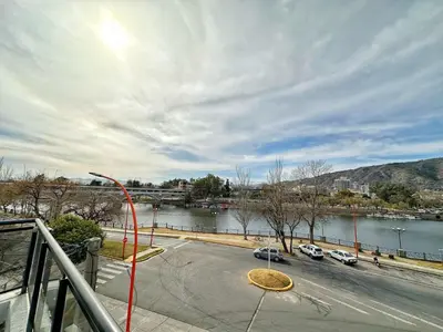 a view of a street with cars parked next to a river at Veneto II in Villa Carlos Paz