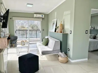 a living room with a couch and a bed at Veneto II in Villa Carlos Paz