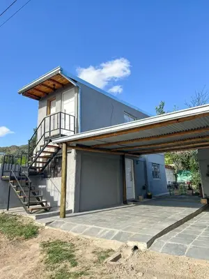 a building with a staircase on the side of it at Monoambiente calamuchita in Santa Rosa de Calamuchita