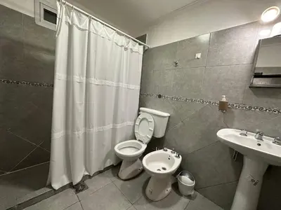 a bathroom with a toilet and a sink at AGRADABLE Dpto. pasaje Tucumán in Alta Gracia