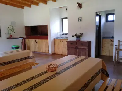 a large room with two beds and a kitchen at Estilos Argentinos in Los Reartes