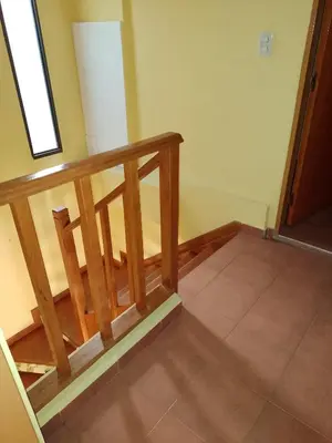 a stairway with a wooden rail and a floor at Aparts Altos del Centro in Merlo