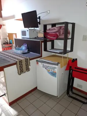 a kitchen with a refrigerator and a shelf on top of it at Aparts Altos del Centro in Merlo
