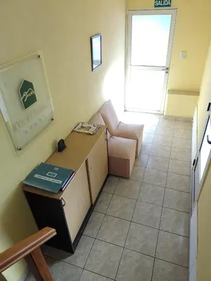 a small living room with a couch and a chair at Aparts Altos del Centro in Merlo