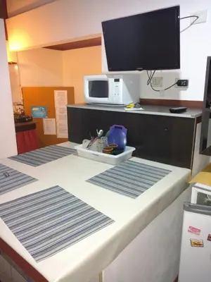 a hotel room with a bed with a tv on it at Aparts Altos del Centro in Merlo