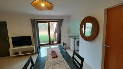 a dining room with a table and a mirror at Duplex Zekkei in Villa General Belgrano