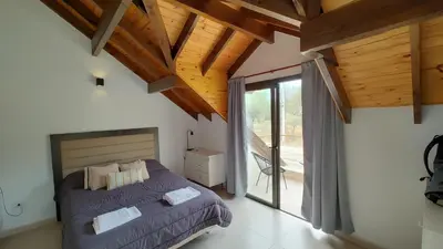 a bedroom with a bed and a large window at Duplex Zekkei in Villa General Belgrano