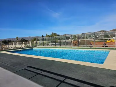 a large swimming pool with a fence around it at La Palmerita 9 in Villa Carlos Paz