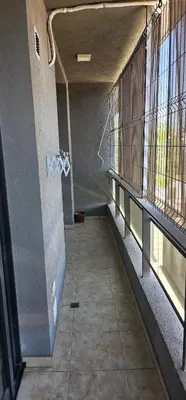 an empty hallway of a building with windows and a staircase at La Palmerita 9 in Villa Carlos Paz