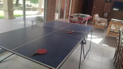 a ping pong table with a ping paddle on it at QUINTA LA ESTELA in Pilar