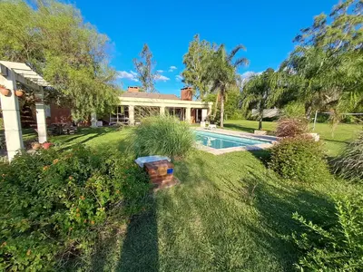 a house with a swimming pool in a yard at QUINTA LA ESTELA in Pilar
