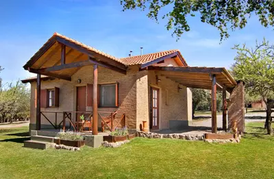 a brick house with a roof at Complejo el Paine in Villa General Belgrano