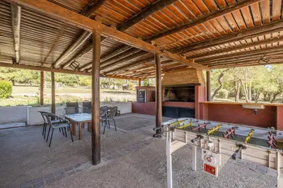 an outdoor patio with a table and ping pong balls at Complejo el Paine in Villa General Belgrano
