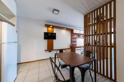 a kitchen with a table and chairs and a refrigerator at La Rioja 1092 B Alberdi in Cordoba