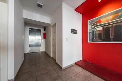 a hallway with red and white walls and a red wall at La Rioja 1092 B Alberdi in Cordoba