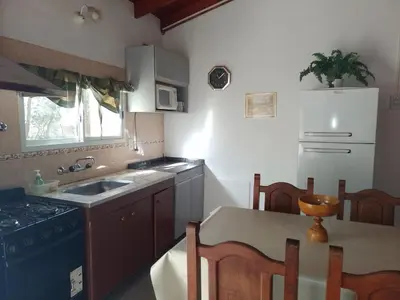 a kitchen with a sink and a stove at Cabañas Altos del Centro in Merlo