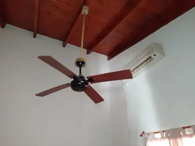 a ceiling fan hanging from a ceiling at Cabañas Altos del Centro in Merlo