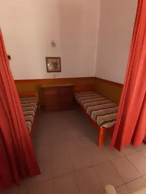 a room with two benches and red curtains at Cabañas Altos del Centro in Merlo