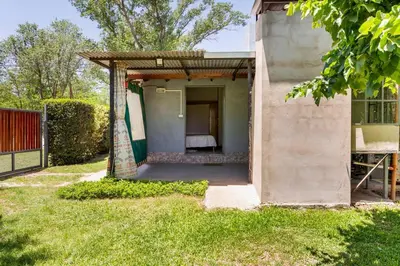 a small house with a bed in a yard at Habitación Suite Sami Llankay in Villa Ciudad Parque