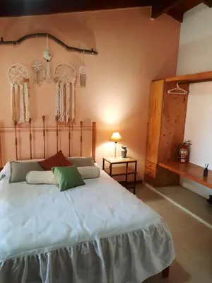 a bedroom with a large bed in a room at Habitación Suite Sami Llankay in Villa Ciudad Parque