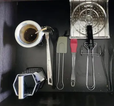 a drawer with a cup of coffee and other kitchen utensils at Bello Dpto, 20 minutos al Estadio Kempes, cerca de Quality, Hospital Privado in Cordoba