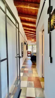 a hallway with a wooden ceiling and a tile floor at Suite para dos con entrada independiente in Merlo