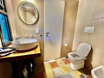 a bathroom with a sink and a toilet and a mirror at Suite para dos con entrada independiente in Merlo