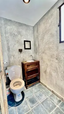 a bathroom with a toilet and a sink at Suite para dos con entrada independiente in Merlo