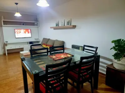 a dining room with a glass table and chairs at Departamento 2 ambientes. 2 cuadras de Patio Olmos in Cordoba