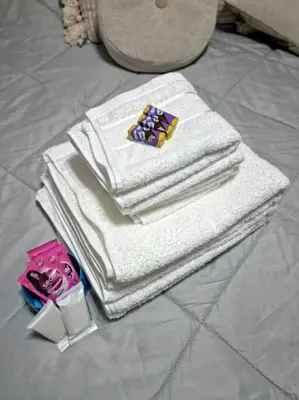 a pile of towels sitting on top of a bed at Departamento 2 ambientes. 2 cuadras de Patio Olmos in Cordoba