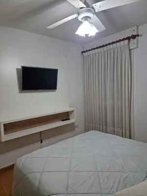 a bedroom with a bed and a flat screen tv at Departamento 2 ambientes. 2 cuadras de Patio Olmos in Cordoba