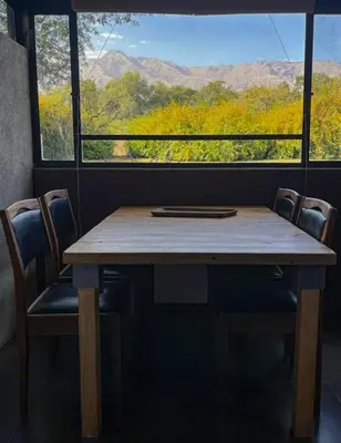 a table with chairs and a window with a view at Las Rukas in San Javier