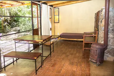 a room with tables and a bed and a window at Las Rukas in San Javier