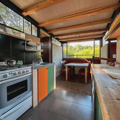 a kitchen with a stove and a dining room with a table at Las Rukas in San Javier