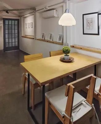 a dining room with a wooden table and chairs at CASA TRANSFORMER in Cordoba
