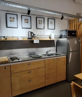 a kitchen with a sink and a refrigerator at CASA TRANSFORMER in Cordoba