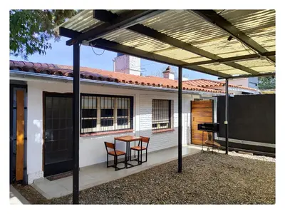 a patio with a table and chairs in front of a house at CASA TRANSFORMER in Cordoba