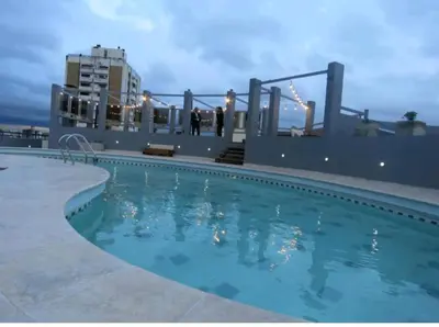 a swimming pool on the roof of a building at Departamento NYC 2 - Edificio VILAUT by INMOVE Temporarios in Cordoba