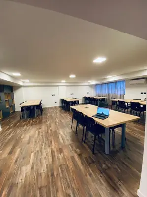 an empty room with tables and chairs and a laptop at Departamento NYC 2 - Edificio VILAUT by INMOVE Temporarios in Cordoba
