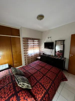 a hotel room with a bed and a dresser at ALQUILO DEPTO AMUEBLADO 2 DORMITORIOS EN MICROCENTRO in Río Cuarto