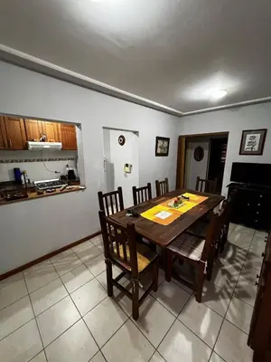 a dining room with a wooden table and chairs at ALQUILO DEPTO AMUEBLADO 2 DORMITORIOS EN MICROCENTRO in Río Cuarto