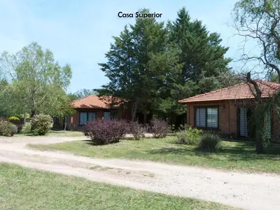 a house with a dirt road in front of it at Yerba Buena casas de campo - Arroyo de los Patos in Nono