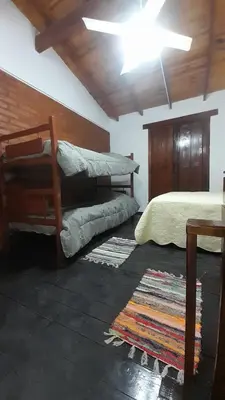 a bedroom with two bunk beds and a ceiling at POSADA LAS MARGARITAS in Santa Rosa de Calamuchita