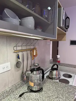 a kitchen counter with a tea pot and pans on it at Paseo Quattro Villa Carlos Paz in Villa Carlos Paz